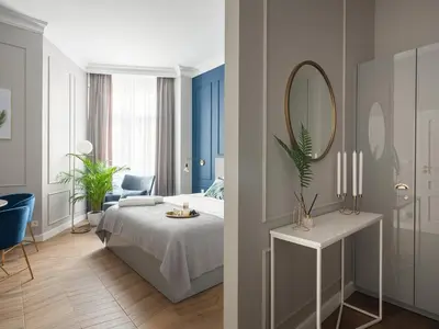 a bedroom with a bed and a mirror at Luxury Gold Cracow City Centre 3min Main Sq Old Town in Kraków