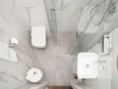 a white bathroom with a toilet and a shower at Luxury Gold Cracow City Centre 3min Main Sq Old Town in Kraków
