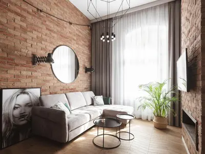 a living room with a couch and a brick wall at Loft Apartment Cracow Old Town 3min Main Sq in Kraków