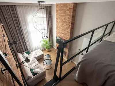 a loft bedroom with a bed and a couch at Loft Apartment Cracow Old Town 3min Main Sq in Kraków