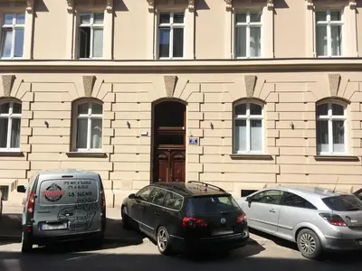 two cars parked in front of a building at Loft Apartment Cracow Old Town 3min Main Sq in Kraków