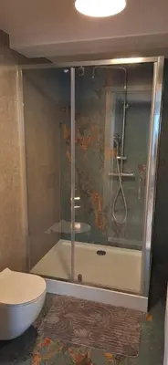 a bathroom with a shower with a toilet and a sink at Noclegi pod Brzegiem in Zawoja