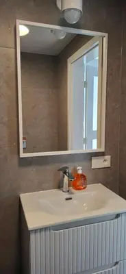 a bathroom with a sink and a mirror at Noclegi pod Brzegiem in Zawoja
