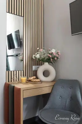 a room with a desk with a chair and a mirror at Platinum Suites in Kraków