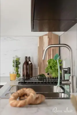 a bagel sitting on a kitchen counter next to a sink at Platinum Suites in Kraków