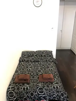 a bedroom with two beds with black and white bedding at D&A Apartmetns Lenartowicza in Kraków