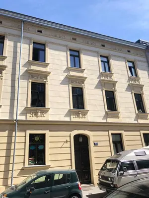 a building with two cars parked in front of it at D&A Apartmetns Lenartowicza in Kraków
