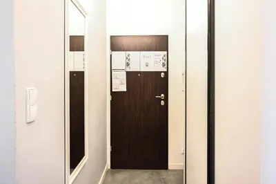 a door in a hallway with a mirror at D&A Apartmetns Lenartowicza in Kraków