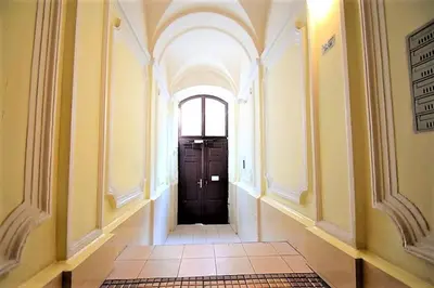 a hallway with a black door in a building at Studio blisko Wawelu in Kraków