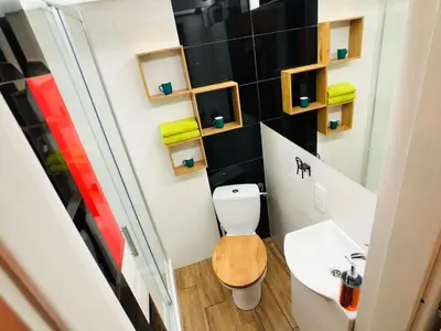 a small bathroom with a toilet and a sink at Studio blisko Wawelu in Kraków