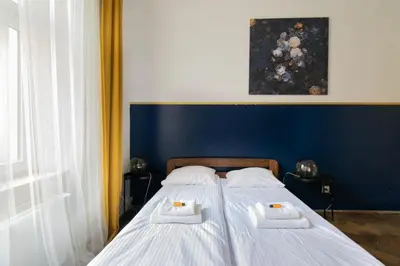 a bedroom with two beds with towels on them at Cozy Apartments Krakowska Street, Kazimierz District in Kraków