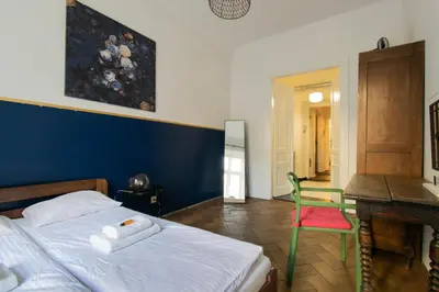 a bedroom with a bed and a desk and a chair at Cozy Apartments Krakowska Street, Kazimierz District in Kraków