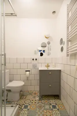 a white bathroom with a toilet and a sink at Cozy Apartments Krakowska Street, Kazimierz District in Kraków