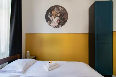 a bedroom with a bed and a plate on the wall at Cozy Apartments Krakowska Street, Kazimierz District in Kraków