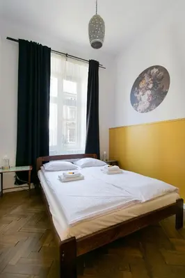 a bedroom with a bed with two plates on it at Cozy Apartments Krakowska Street, Kazimierz District in Kraków