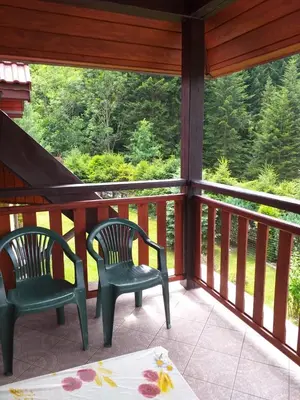 two chairs on a screened in porch with a view at Zawojka in Zawoja