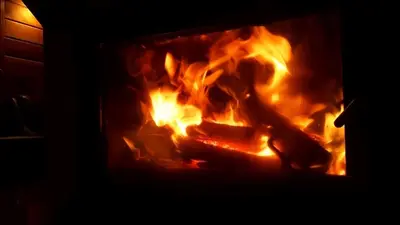 a fire burns inside of a fireplace at Zawojka in Zawoja
