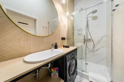 a bathroom with a sink and a shower at Apartament Deluxe Old Town św. Krzyża WAWELOFTS in Kraków