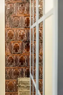 a brick wall with a bunch of chocolate squares at Apartament Deluxe Old Town św. Krzyża WAWELOFTS in Kraków