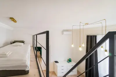 a bedroom with a bed and a mirror at Apartament Deluxe Old Town św. Krzyża WAWELOFTS in Kraków