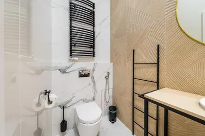 a bathroom with a toilet and a sink at Apartament Deluxe Old Town św. Krzyża WAWELOFTS in Kraków