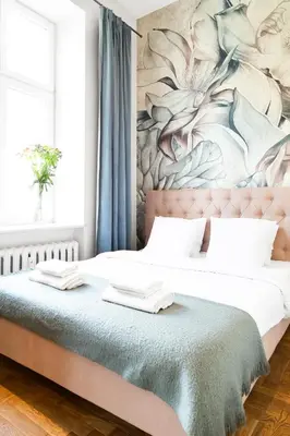 a bedroom with two beds with a painting on the wall at HOUSEHOST Apartment: Łazarza street in Kraków