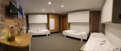 a hospital room with two beds and a table at Pokoje Wieliczka in Wieliczka