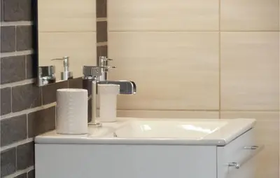 a bathroom with a sink and a toilet paper at One-Bedroom Holiday Home In Biadoliny Szlachecki in Biadoliny Szlacaheckie