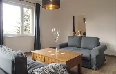 a living room with a couch and a coffee table at One-Bedroom Holiday Home In Biadoliny Szlachecki in Biadoliny Szlacaheckie