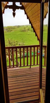 a porch with a view of a green field at Domek Agroturystyczny na Putówce in Słopnice