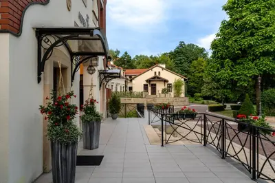 a walkway leading to a house with flowers in vases at Grand Sal in Wieliczka