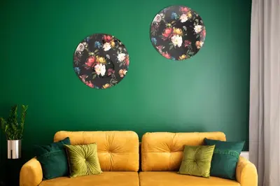 a living room with a couch and three plates on a green wall at Tomasza 20 Apartments in Kraków