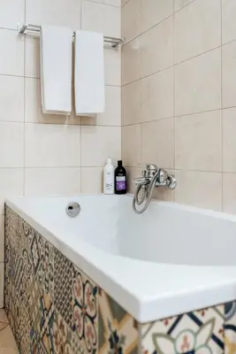 a white sink in a bathroom with white towels at Tomasza 20 Apartments in Kraków