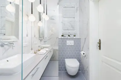 a white bathroom with a toilet and a sink at NY Residence Apartments Wrocławska Cracow by Renters Prestige in Kraków