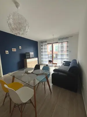 a living room with a couch and a table and chairs at Way2Stay Browar Lubicz in Kraków