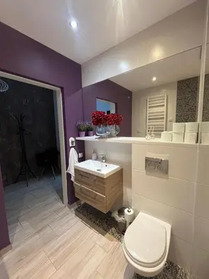 a bathroom with a white toilet and a sink at Way2Stay Browar Lubicz in Kraków