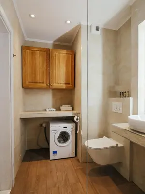a bathroom with a washing machine and a toilet at Way2Stay Browar Lubicz in Kraków