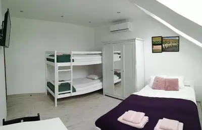 a small room with a bed and bunk beds at Pokoje pod Baranami Zator Przeciszów in Przeciszów