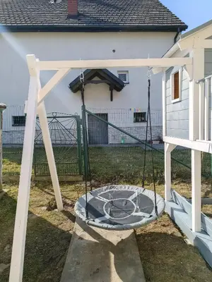 a swing set in the backyard of a house at Pokoje pod Baranami Zator Przeciszów in Przeciszów