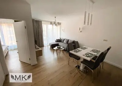 a living room with a couch and a tv at MK Angel Apartment in Kraków