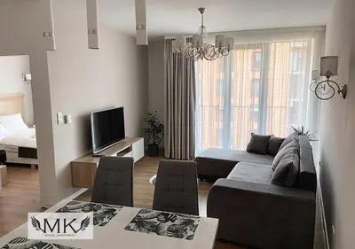 a bedroom with a bed and a chair in a room at MK Angel Apartment in Kraków