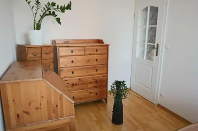 a bedroom with a dresser and a chest of drawers at Cosy and Comfortable Apartment in Cracov in Kraków