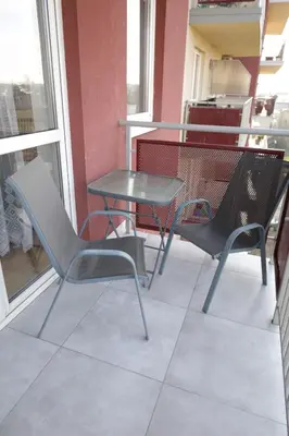 a table and chairs sitting on a balcony at Cosy and Comfortable Apartment in Cracov in Kraków