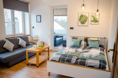 a bedroom with a bed and a couch at GOLDEN ROOMS blisko Energylandii in Zator