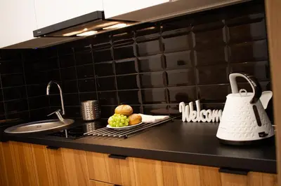 a kitchen counter with a sink and a plate of food at GOLDEN ROOMS blisko Energylandii in Zator