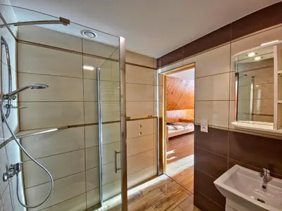 a bathroom with a shower and a sink at U Zosi in PyzÃ³wka