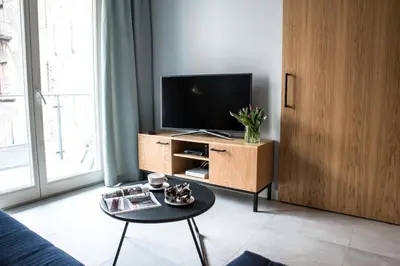 a living room with a tv and a coffee table at Augustiańska in Kraków