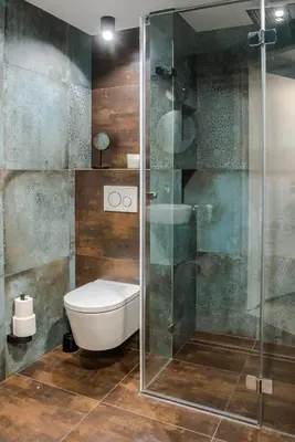 a bathroom with a toilet and a glass shower at Augustiańska in Kraków