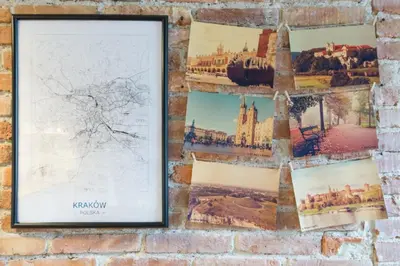 a wall of photographs on a brick wall at Discover Krakow Apartments - 3 Rakowicka St - Amazing Loft near Main Station - Netflix in Kraków