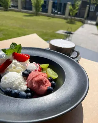 a bowl of food with fruit on a table at Discover Krakow Apartments - 3 Rakowicka St - Amazing Loft near Main Station - Netflix in Kraków